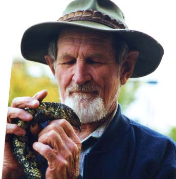 Harry Butler holding a lizard